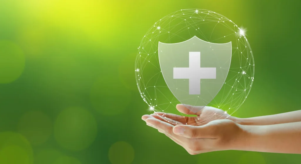 A green background with a hand holding a bubble that contains a shield with a cross on it. This symbolises that health and safety element of this course.